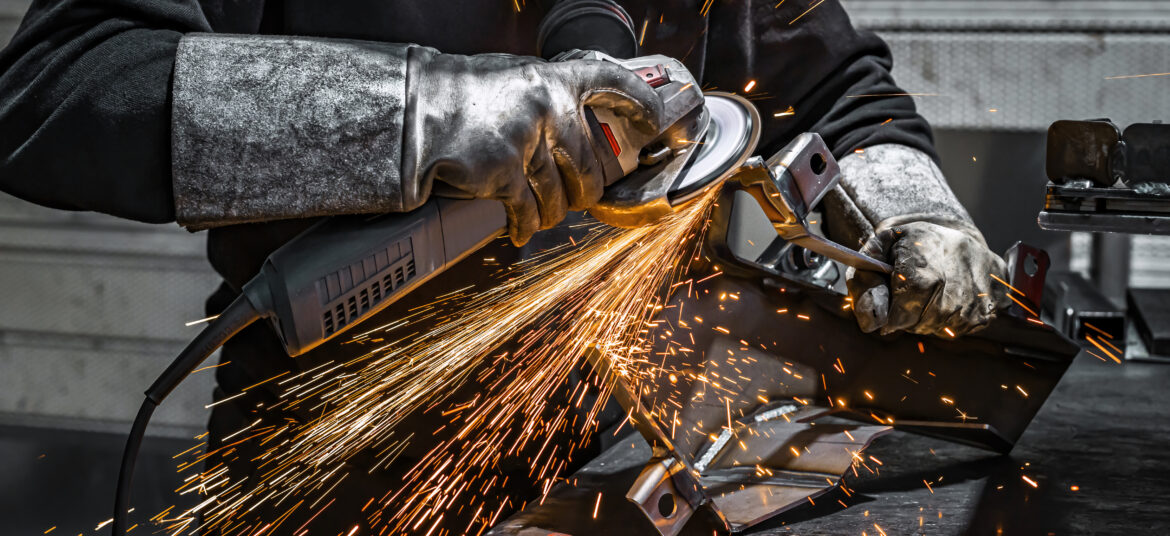 Worker grinding metal